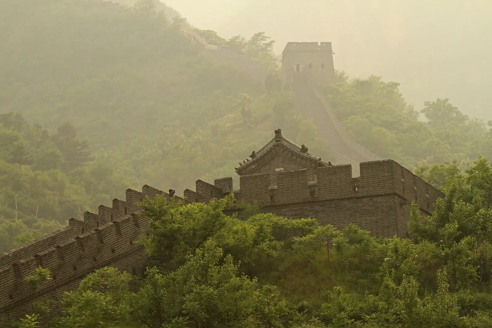 A Great Wall tower and wall in morning mist at Huangyaguan